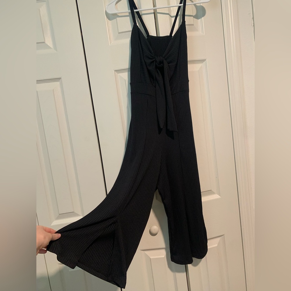 Cute ribbed black jumpsuit with cutout front and cut legs